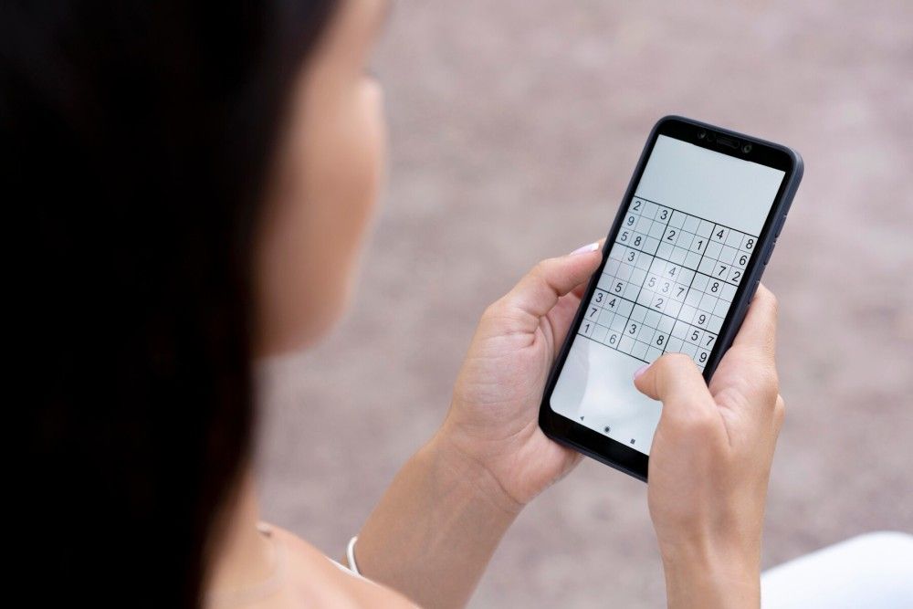 Person playing Sudoku